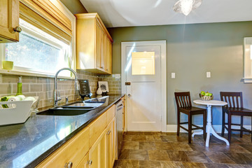 Kitchen room with maple storage cabinets and dining area