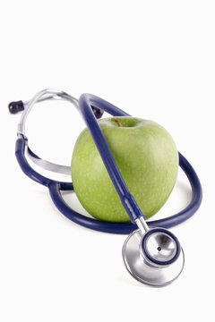 Stethoscope and green apple isolated on white background ,