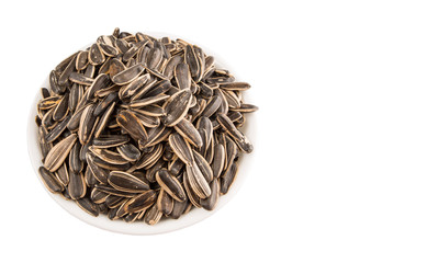 Sunflower seeds in white bowl over white background