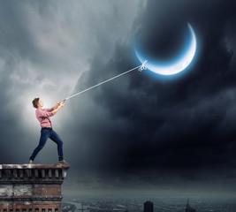 Man pulling moon