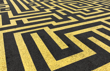 Yellow labyrinth painted on a black asphalt road
