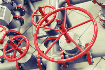 Red industrial valves on modern pipeline system