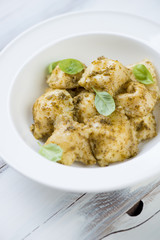 Ravioli with pesto sauce in a plate, close-up, vertical shot