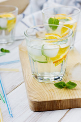 Water with limes, oranges, lemons, ice and mint