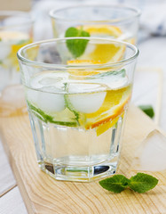 Water with limes, oranges, lemons, ice and mint