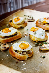 Sandwich with fried quail eggs, mushrooms and toast