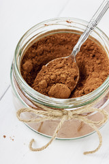 Cocoa powder in a glass bowl with a spoon