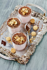 Milkshake with chocolate and cookies on a vintage wooden board