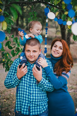 Happy family have birthday party with blue decorations in forest