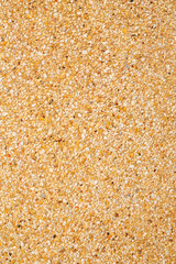 Gravel texture on brown concrete wall