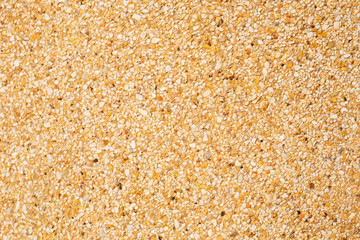 Gravel texture on brown concrete wall