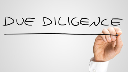 Man writing Due Diligence on a virtual interface