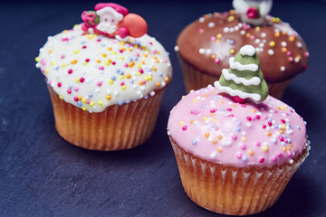 Christmas cupcakes, different colors on black slate