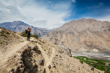 Fototapeta na wymiar Photographer taking photos in Himalayas