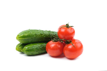 Fresh tomatoes and cucumbers isolated on a white background