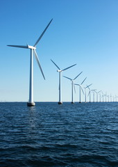 Vertical perspective of ocean windmills with horizon