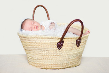Baby girl sleeping in a shopping basket © aniad