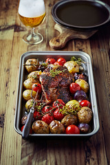 Roast pork with vegetables and herbs 