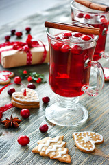 Mulled wine with cranberry, cookies and christmas decorations