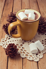 Hot chocolate and marshmallows on wooden table
