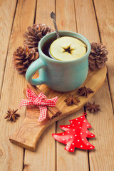 Hot drink with apple and spices for Christmas celebration