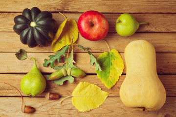 Autumn pumpkin and fruits on wooden table