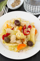fish salad in white plate and glass of water
