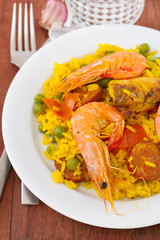 paella on white plate and water