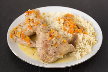 rabbit with rice on plate on black background