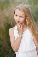 portrait of little girl outdoors in summer