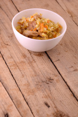 Chinese cuisine - fried rice with meat on wooden background