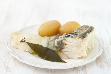cod fish with potato on white plate