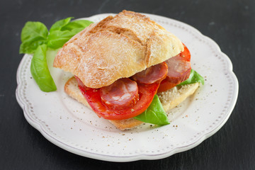 bread with chourico, basil and tomato