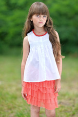 Fototapeta premium portrait of little girl outdoors in summer