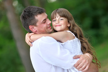 Fototapeta premium portrait of a happy family in summer nature