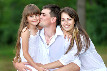 portrait of a happy family in summer nature