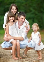 Fototapeta premium portrait of a happy family in summer nature