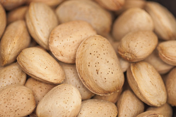 Some almonds in wooden background