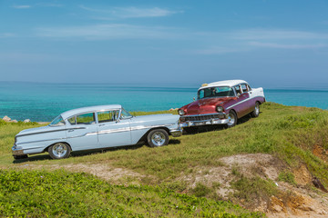 amazing view of old vintage classic cars on ocean background