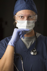 Concerned Female Doctor or Nurse Wearing Protective Facial Wear