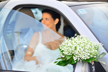 Bride going out of the car smiling