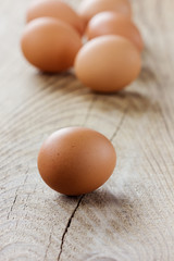 Brown eggs on old table, rustic style