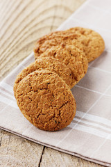 Oatmeal cookies on a linen napkin on old wooden table