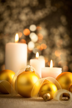 Christmas  background with golden boubles and candles
