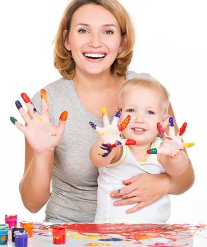 Happy young mother and child with painted hands.