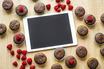 Muffins and tablet on the table
