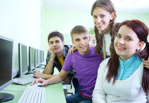 group of students studying with computer