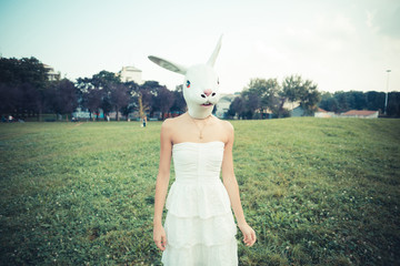 rabbit mask absurd beautiful young woman with white dress