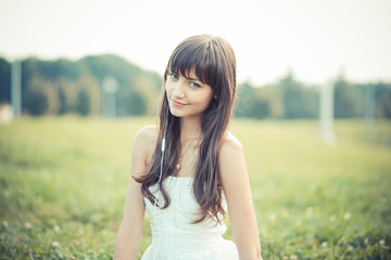 Fototapeta premium beautiful young woman with white dress listening music