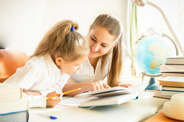 mother helping daughter with homework